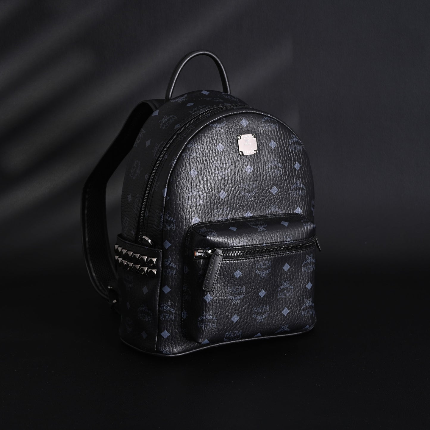 MCM Stark Visetos Medium Backpack – Black Monogram with Studded Detailing