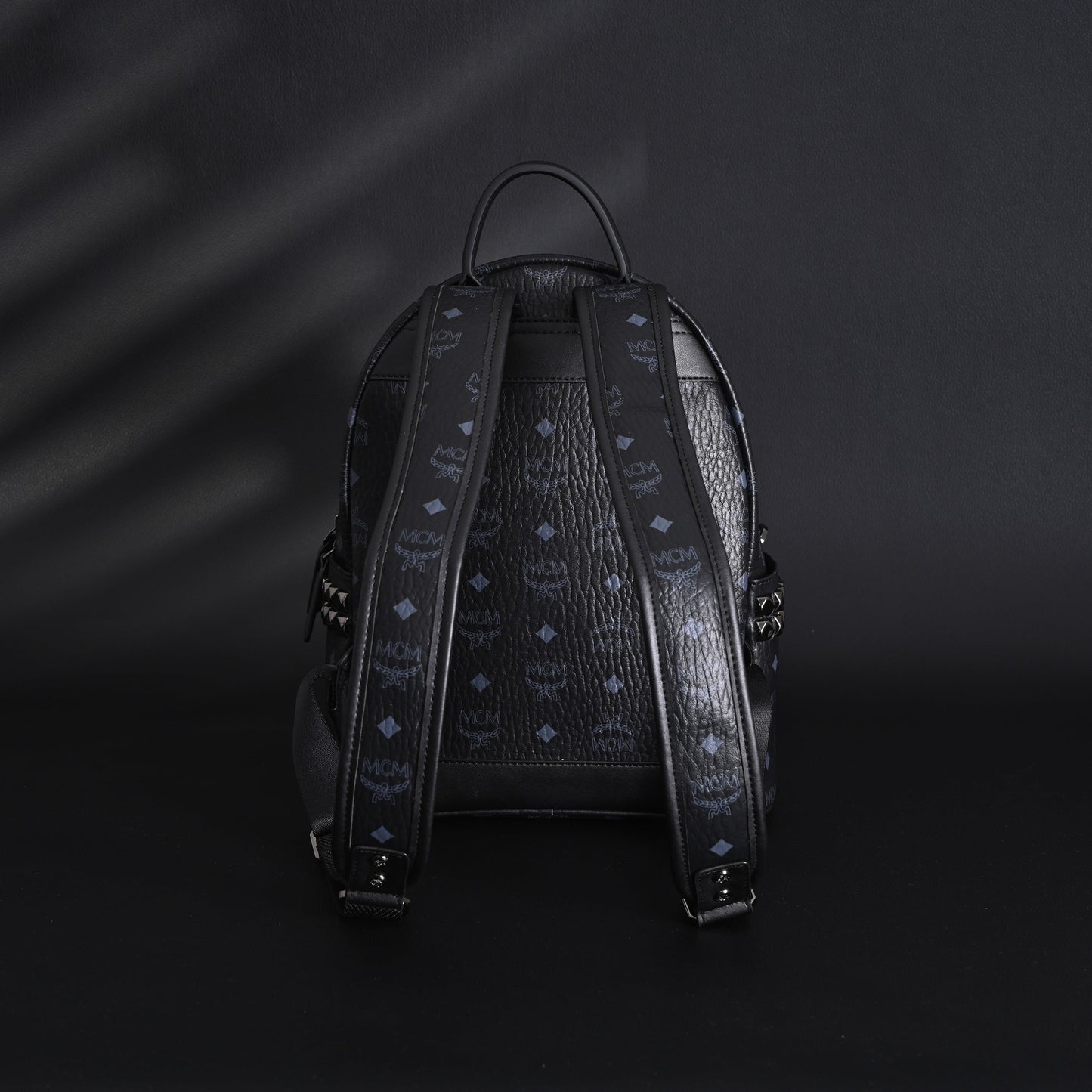 MCM Stark Visetos Medium Backpack – Black Monogram with Studded Detailing