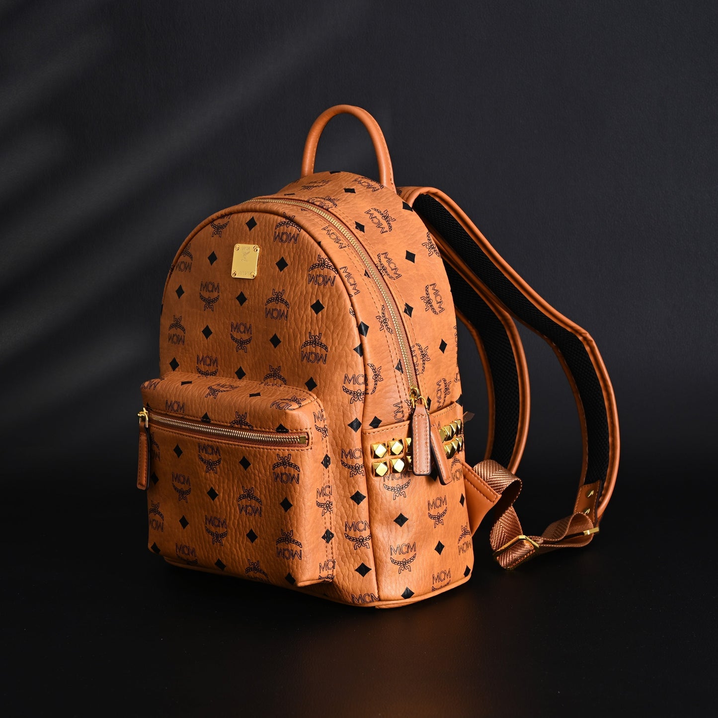 MCM Stark Visetos Medium Backpack – Cognac Monogram with Gold-Tone Studs