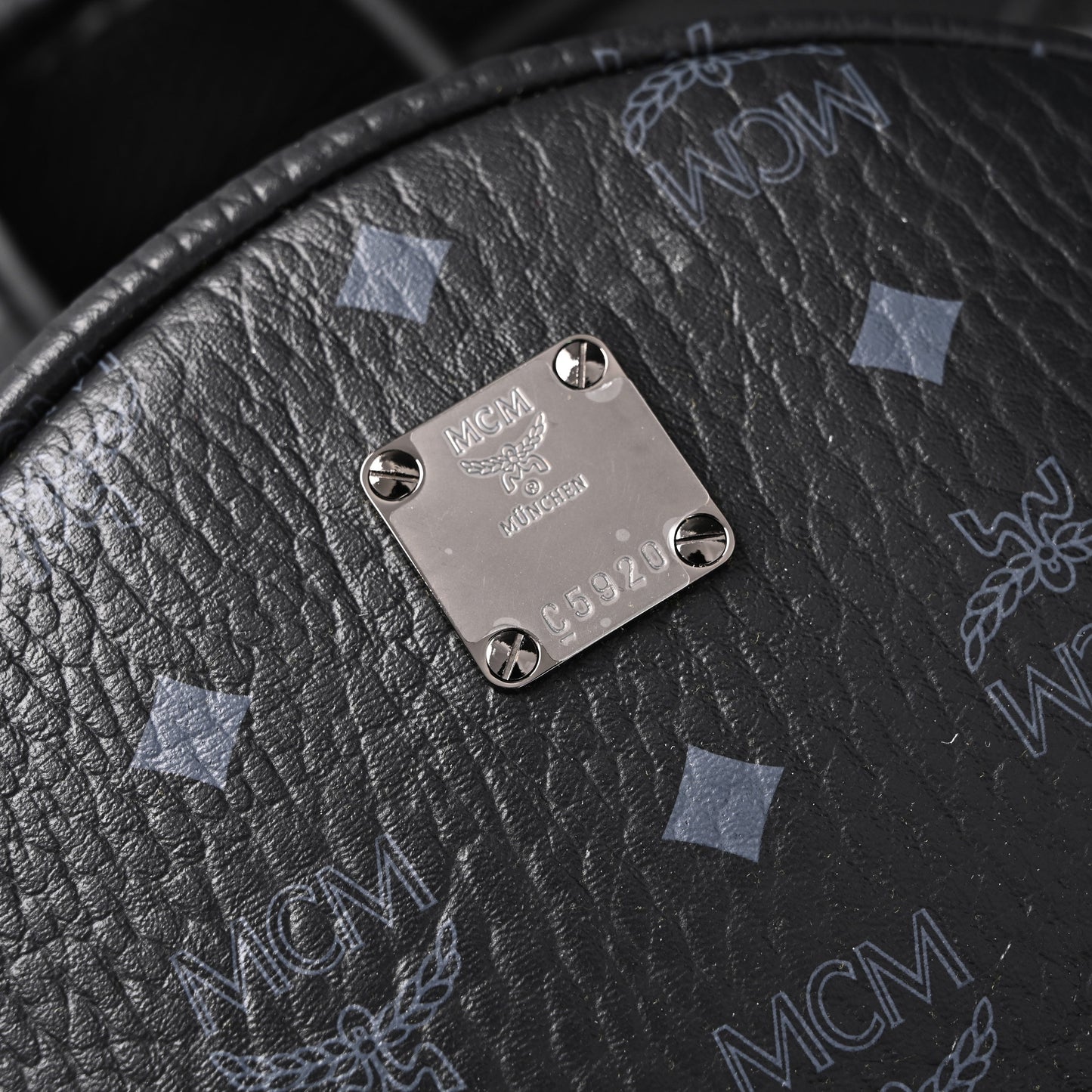 MCM Stark Visetos Medium Backpack – Black Monogram with Studded Detailing