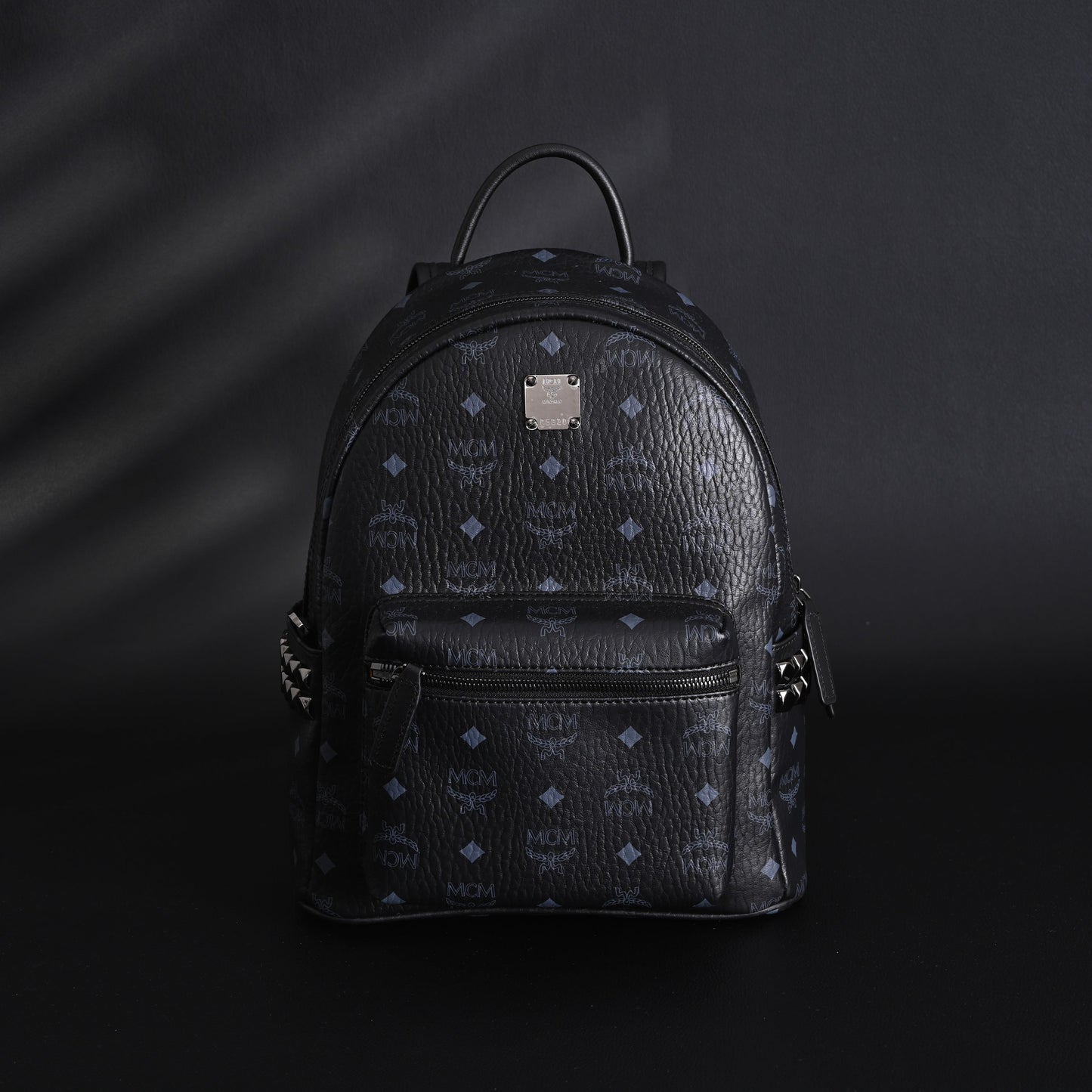 MCM Stark Visetos Medium Backpack – Black Monogram with Studded Detailing