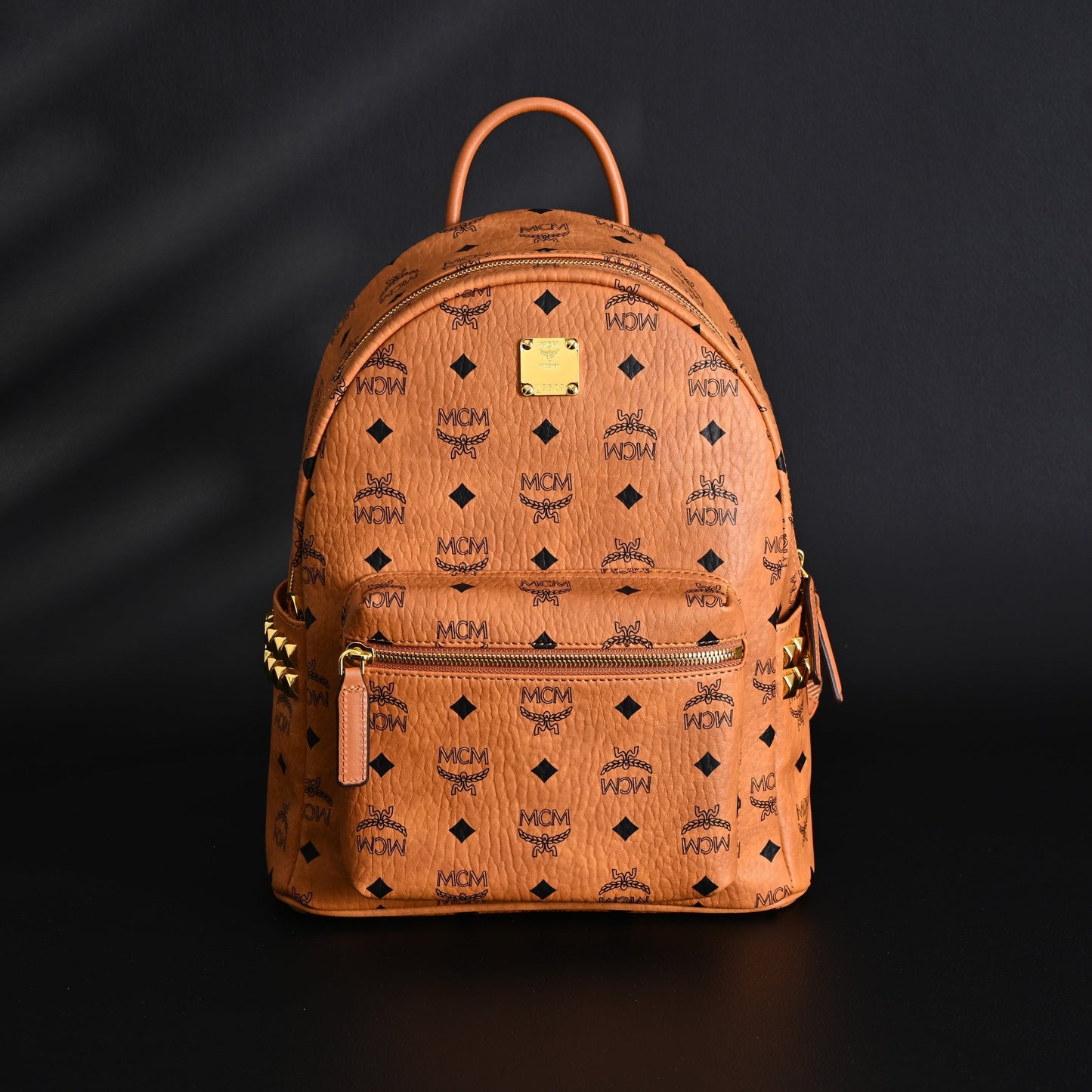 MCM Stark Visetos Medium Backpack – Cognac Monogram with Gold-Tone Studs